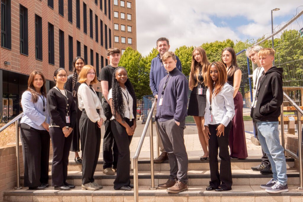 Shaun Davies MP, along with the 2026 Summer School students, with the Telford skyline in the background